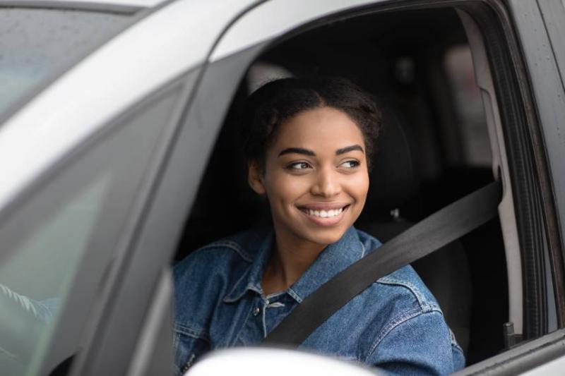 Image of a black woman driving a car.