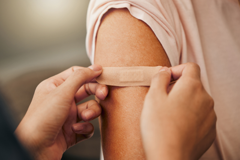 picture of someone having plaster put on their arm