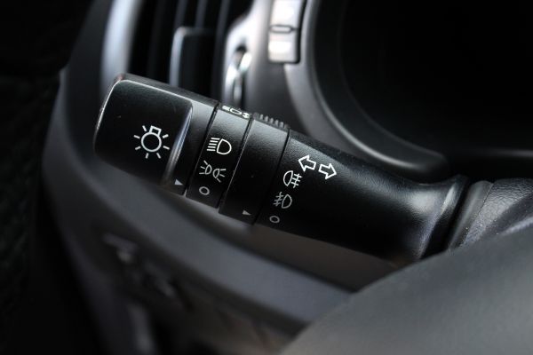 Fog light symbols on a steering wheel stalk, close up