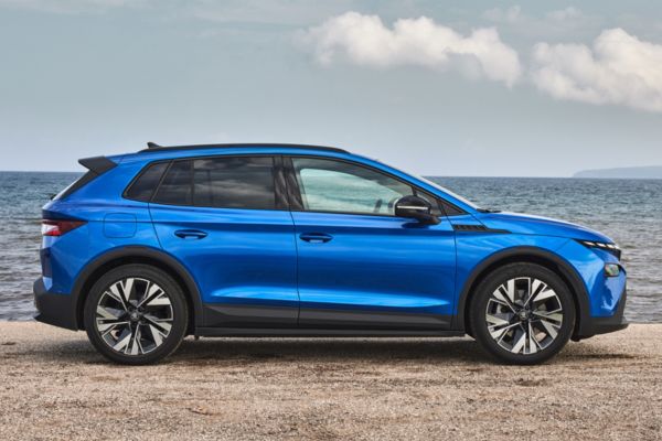 A blue Skoda Elroq car on a beach