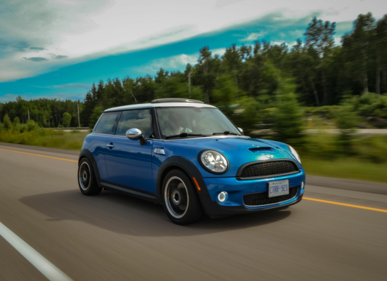 blue mini cooper driving on road