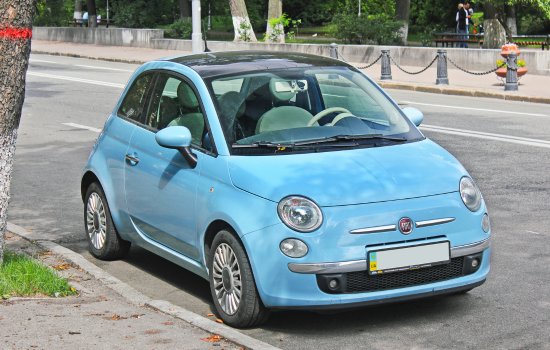 blue fiat 500 parked on street