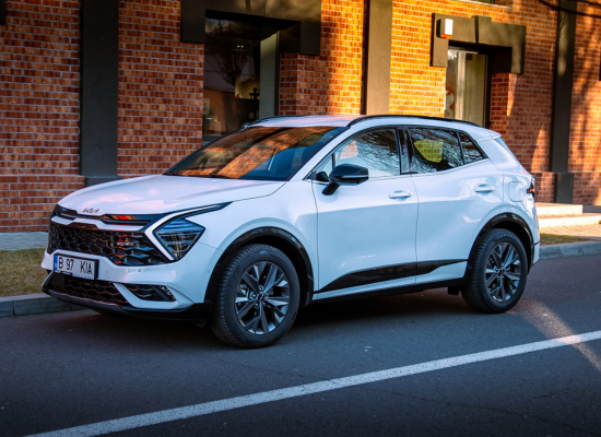 white kia sportage parked on road