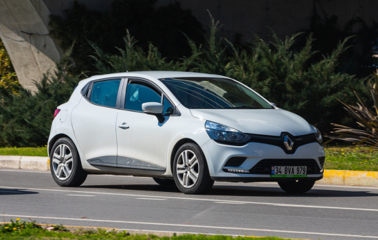 white renault clio driving on road