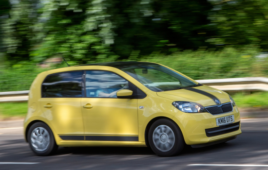 yellow skoda citigo on road