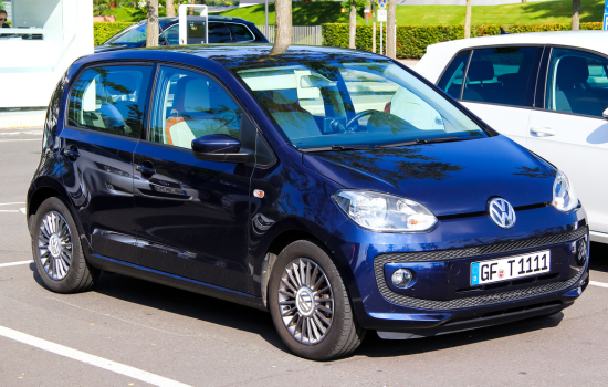 dark blue volkswagen up in car park