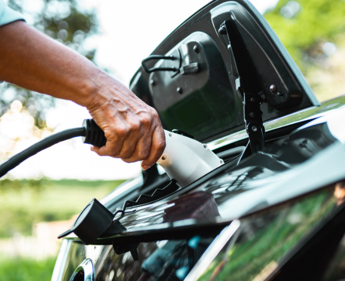 person charging hybrid car