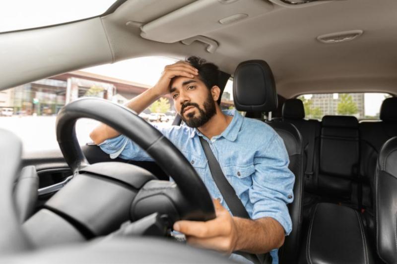 Man in car looking stressed