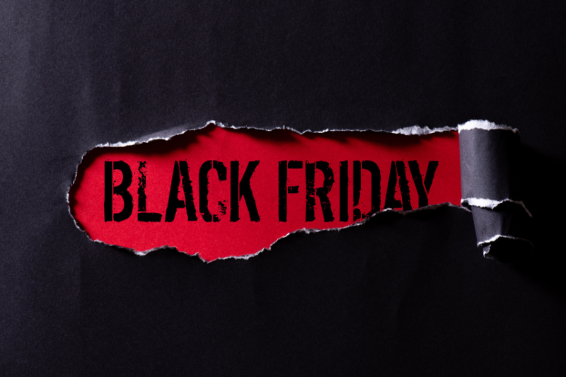 black friday sign showing under ripped paper