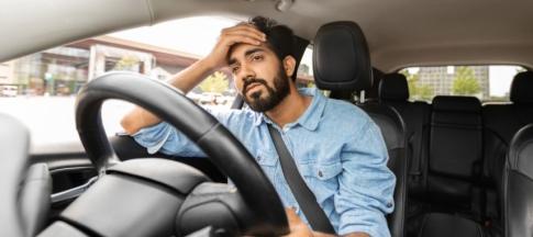 Man in car looking stressed