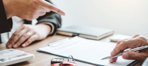 A clipboard with two pairs of hands, and a set of car keys